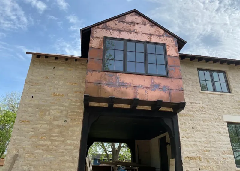 Copper metal panel facade on a stone building for Skylight Installation in Montclair