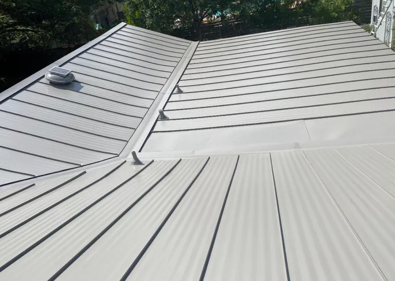 Solar attic fan installed on a metal roof for Roof Ventilation in Montclair